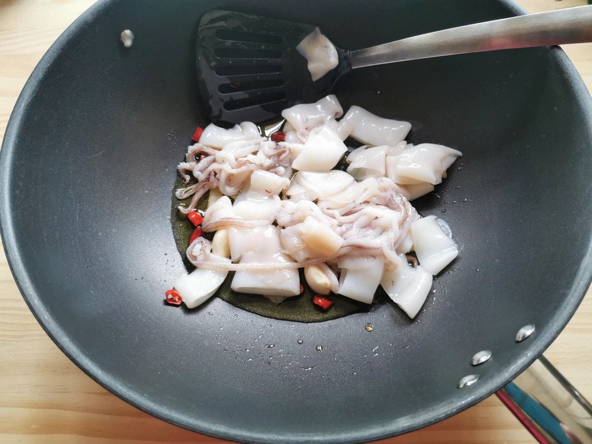 Squid (calamari) added to the pan.