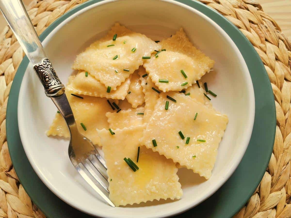 Robiola stuffed ravioli from Lombardy in a white bowl.