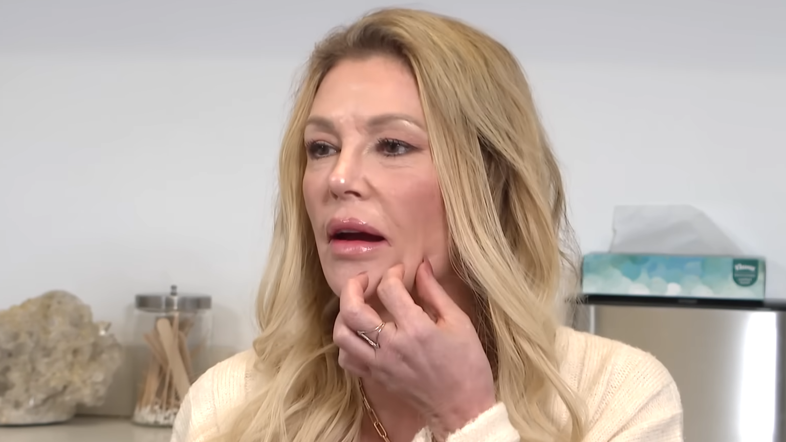 Brandi Glanville gestures to her disfigured face in late 2024.