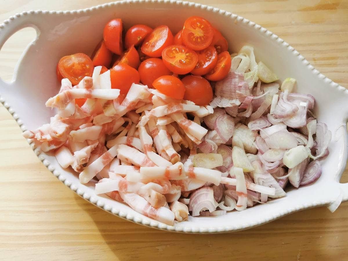 Prepared shawls, guancial and cherry tomatoes in white bowl.