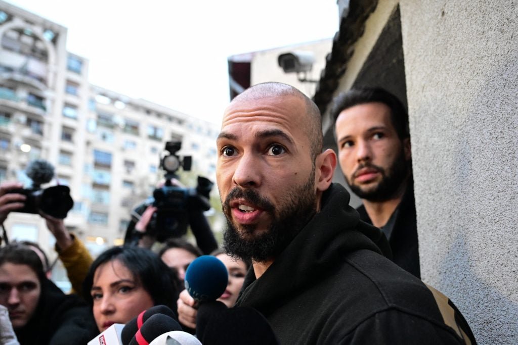 The British-American former professional kickboxes and controversial influencer Andrew Tate (Front) and his brother Tristan Tate (back R) talk to journalists after being released from detention in Bucharest, Romania on March 12, 2024. 