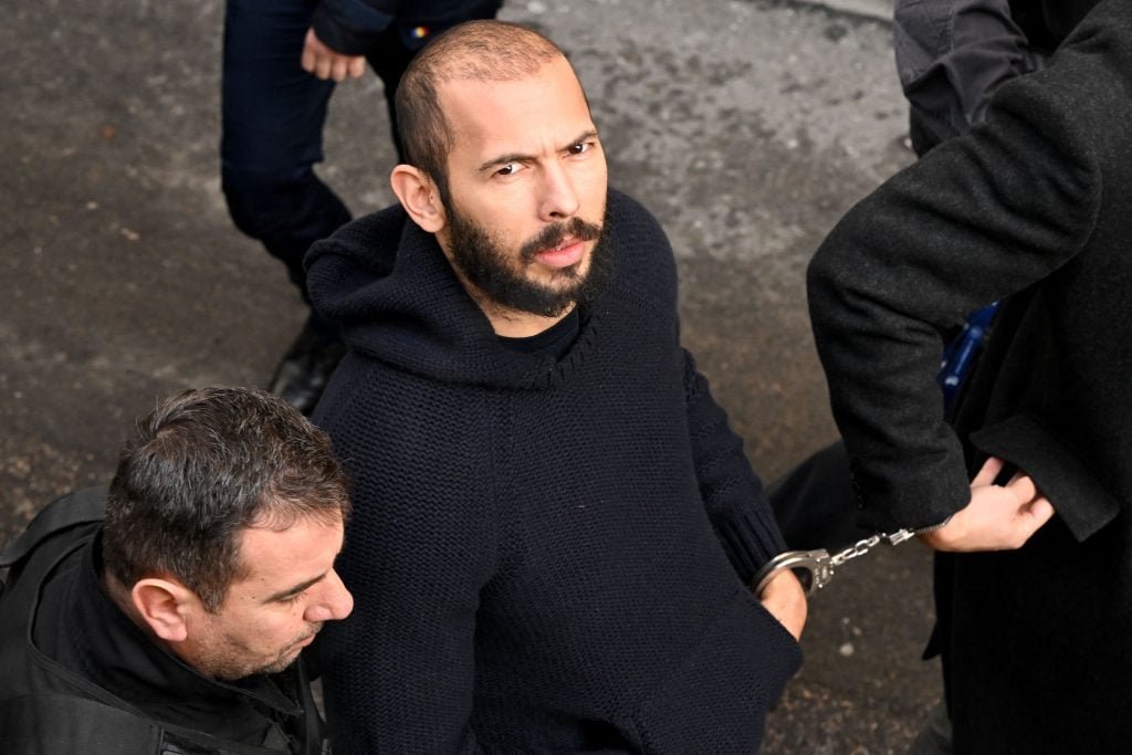 British-American influencer Andrew Tate arrives handcuffs and escorted by police by a court building in Bucharest on February 1, 2023 to hear the court The decision on his appeal against detention of the trial for alleged human trafficking, rape and formation of a criminal group. 