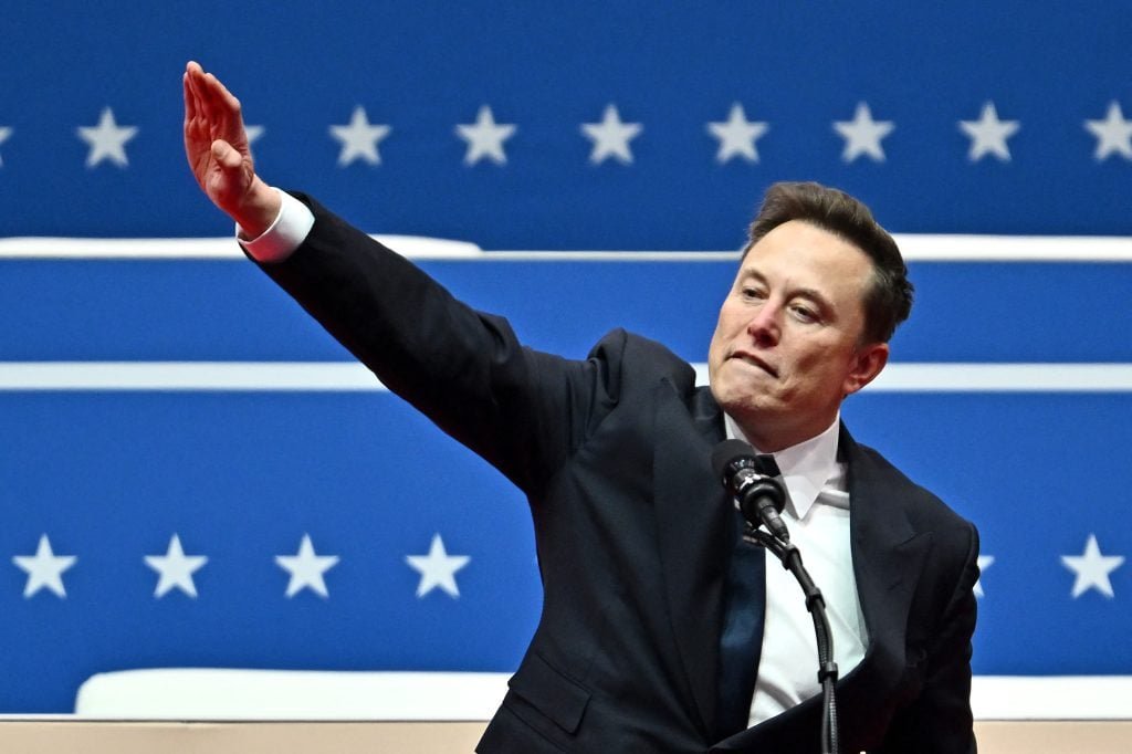 Elon Musk moves as he speaks during the initial parade of Capital One Arena, in Washington, DC, on January 20, 2025.